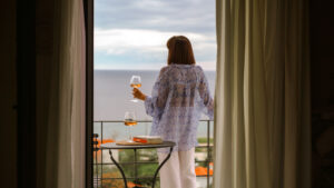 Woman with a glass of wine enjoying the view
